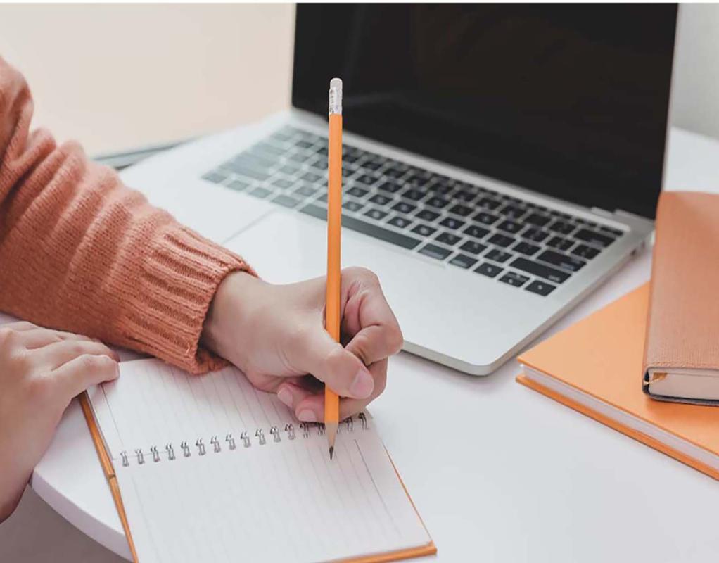 Student writing on a notepad