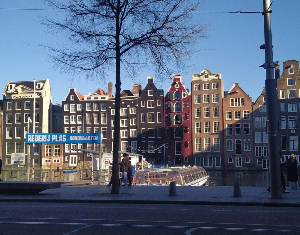 Photo of a boat and canal houses in Amsterdam