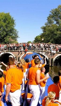 Partying people on a boat in the Amsterdam canal