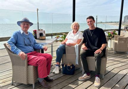 Yurii and his Dutch grandparents near the beach