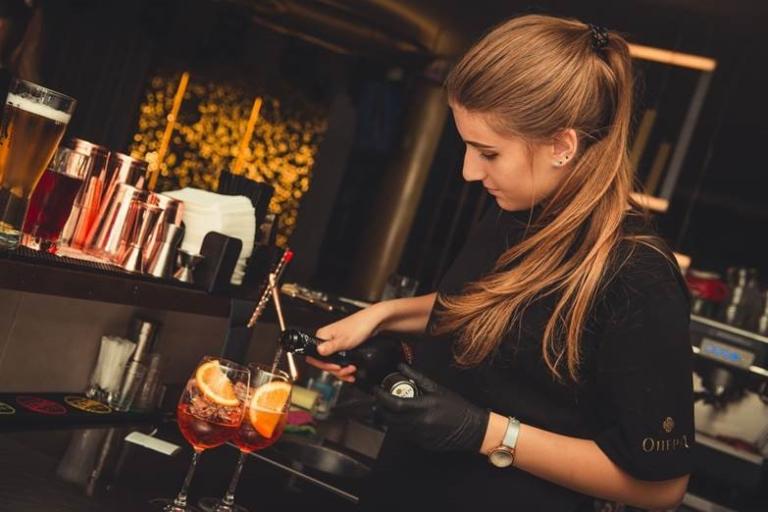 Girl making drinks at a bar