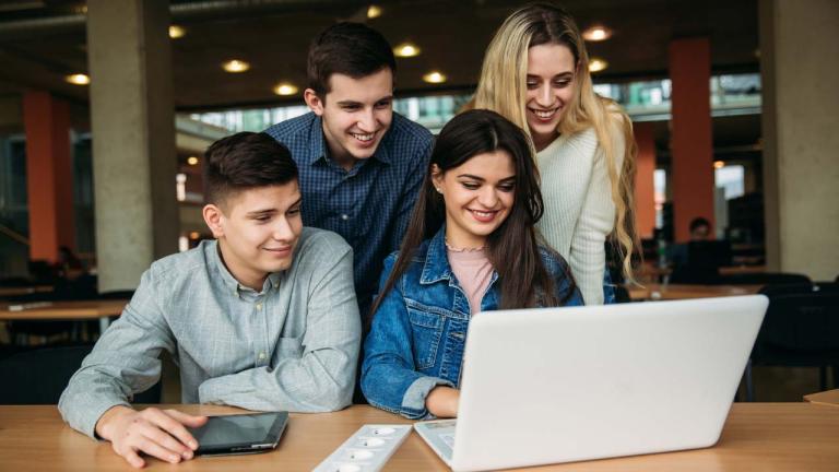 Students behind laptop